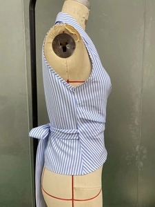 Detail of blue and white striped wrap top with adjustable side waist tie on mannequin