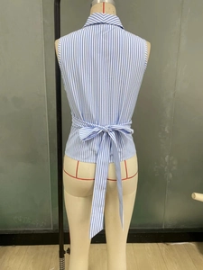 Back view of a blue and white striped sleeveless shirt with a self-tie waist bow detail