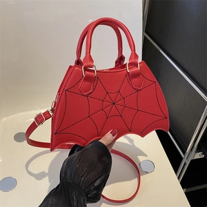 Red bat shaped handbag with black spider web embroidery and adjustable shoulder strap