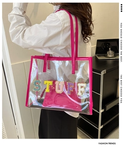 Transparent PVC tote bag featuring pink handles and STUFF chenille patches with inner pouch