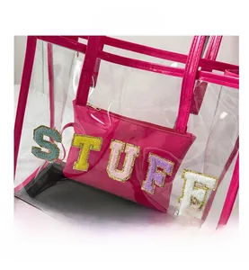 Detail of transparent PVC tote with magenta stitching and STUFF chenille patches