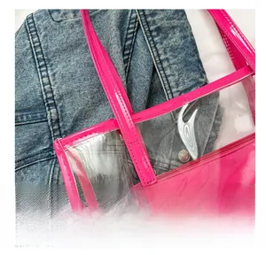 Detail of pink transparent PVC handbag with reinforced stitching and sequined letters