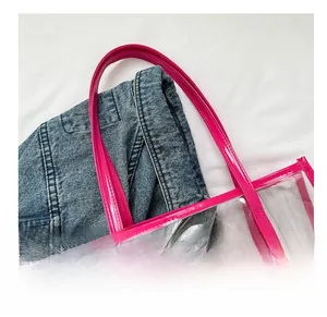 Close-up of bright pink transparent PVC tote bag with shiny faux leather shoulder straps