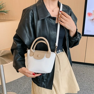 Fashionable white and khaki leather bucket bag with top handle and shoulder strap