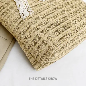 Macro detail of high-density straw weave with elegant white lace trim on the beige bucket bag