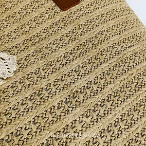Detailed macro shot of straw woven tote with herringbone texture and lace trim edges