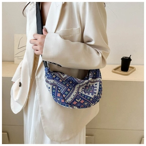 Ethnic knit crescent bag worn with a white blazer for a stylish commuter look
