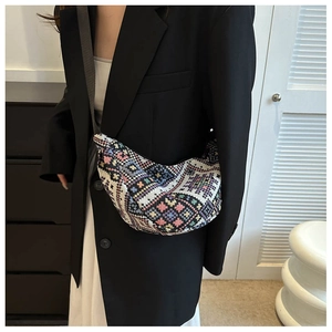 Detail of colorful geometric crochet shoulder bag with intricate woven floral patterns