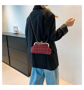 Red tweed chain bag with gold metallic texture worn by a model in a crossbody style