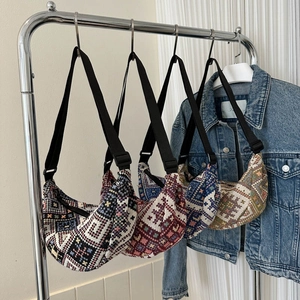 Collection of four bohemian knitted crescent crossbody bags with ethnic geometric patterns