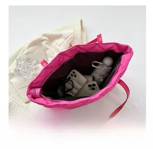 Macro shot of rose pink quilted tote bag interior showing large storage capacity