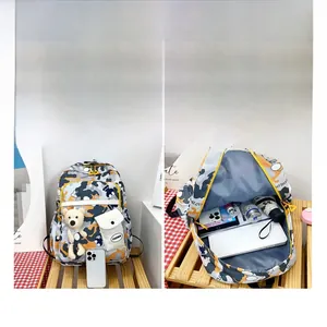 Detailed interior compartments of a floral backpack showing storage for laptop and water bottle