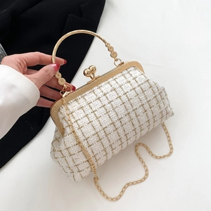 Elegant white tweed handbag with gold handle and flower details on high-quality fabric