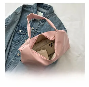 Pink dumpling shaped nylon tote bag showing spacious interior with wallet and umbrella