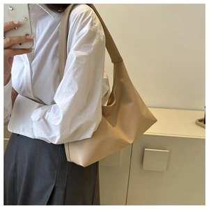 Chic beige hobo shoulder bag styled with white shirt for a modern work look