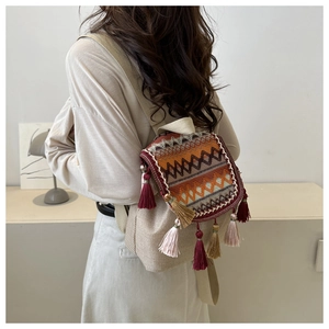 Detail of hand-woven ethnic backpack with colorful tassels and geometric patterns