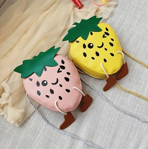 Close-up of strawberry shaped PU leather crossbody bags with cute 3D legs and faces