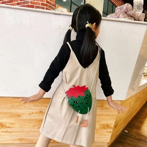 Kid's cute strawberry crossbody bag shown worn by child for size and fit reference