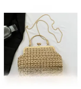 Detail of woven square texture and golden sphere clasp on elegant evening handbag