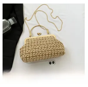 Close-up of woven chain bag with gold beaded handle and vintage metal clasp detail