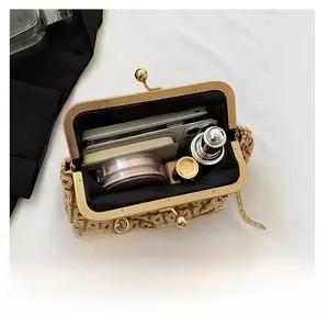 Detail view of woven crossbody bag with gold clasp and large interior storage