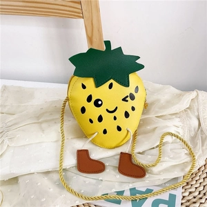 Cute yellow strawberry crossbody bag for kids with cartoon face and little boot charms