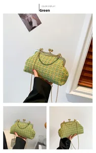 Detail of green woven texture evening bag with vintage gold metal chain and clasp