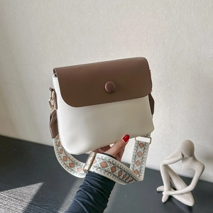 Chic cream and brown crossbody bag with ethnic style jacquard strap and round buckle
