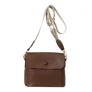 Retro dark brown crossbody bag with bohemian patterned wide strap on white background