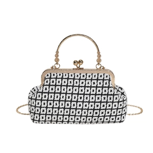 Retro knit doctor bag with black and white geometric pattern and gold metal handle