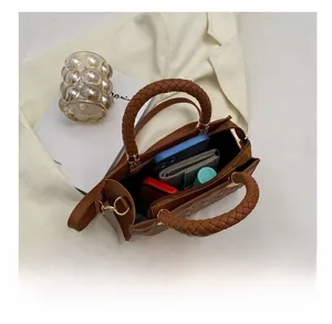 Internal view of brown quilted crossbody bag showing spacious capacity and inner pockets