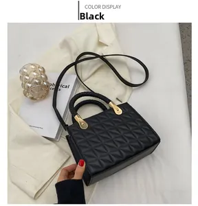 Top view of black quilted crossbody bag with woven handles and gold hardware details