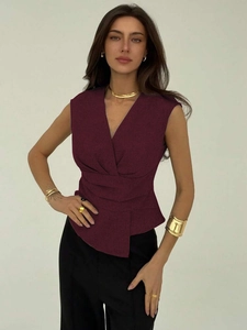 Detail of burgundy V-neck sleeveless top featuring unique gathered waist pleats for women
