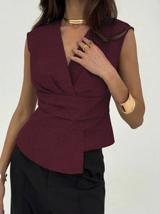 Detail view of deep burgundy sleeveless V-neck top with structured pleated waist design