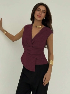 Detail of deep purple V-neck sleeveless top with pleated texture and asymmetric hem