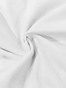 Macro shot of pure white knit fabric showing soft texture and detailed weave patterns