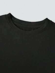 Detail of the crew neck and double-needle stitching on this black casual cotton T-shirt