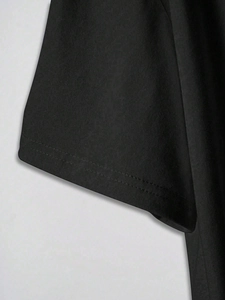 Close-up of double-needle stitching on the cuff of a black cotton casual T-shirt
