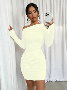 Detail of cream off-shoulder bodycon dress featuring elegant ruched texture and long sleeves