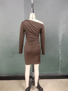 Detail of ruched texture and asymmetrical neckline on brown bodycon dress