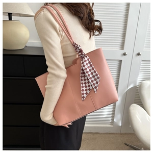 Pale pink faux leather tote bag with stylish plaid scarf detail on handle for daily use