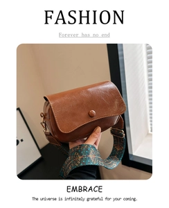 Detail of vintage brown PU saddle bag with bohemian jacquard wide shoulder strap
