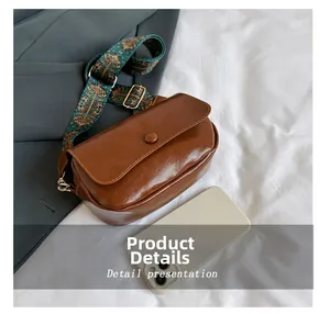 Detailed view of caramel PU leather saddle bag with wide ethnic style shoulder strap