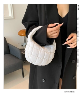 Close-up of a white quilted cloud bag featuring soft padded texture and modern style
