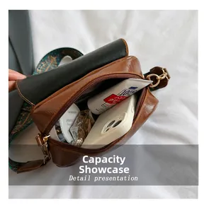 Macro view showing the internal capacity of the brown PU leather crossbody saddle bag