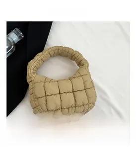 Detail view of khaki quilted cloud tote bag with puffy texture and zip closure