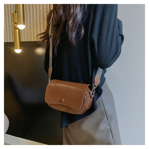 Brown PU leather saddle bag with a stylish wide colorful jacquard shoulder strap