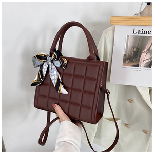 Detail of checkered tote bag in dark brown with elegant decorative silk scarf