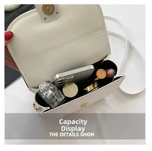 Interior view of white PU leather saddle bag showing capacity for phone and perfume