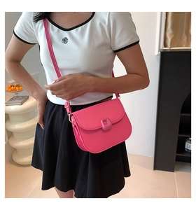 Hot pink PU leather saddle bag with square buckle decoration and adjustable strap detail